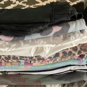 includes a sweater dress, pair of jeans, pair of leggings, and numerous shirts.